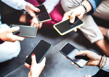 People carrying smartphones in hands