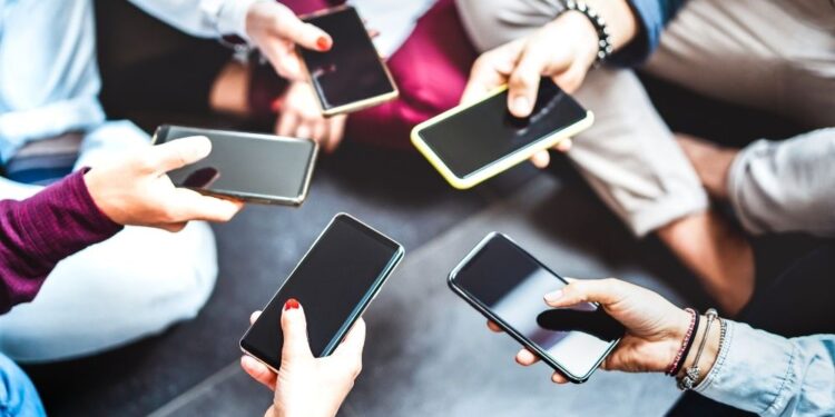 People carrying smartphones in hands